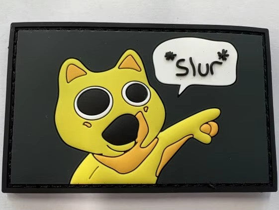 Yellow cartoon character with a speech bubble saying 'Slur' on a black background