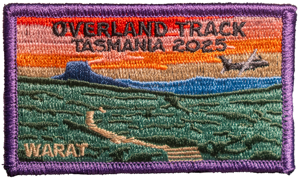Embroidered patch with scenic design and text 'Overland Track Tasmania 2025' on a rectangular background.