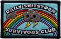 Embroidered patch with rainbow, cloud, and text 'Daily Shitstorm Survivors Club' on a blue background